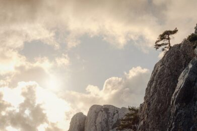 beautiful sunset in mountains, silhouettes of rocks and trees.