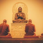 a group of buddha statues sitting on top of a table