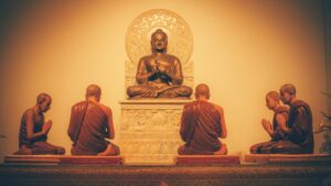 a group of buddha statues sitting on top of a table