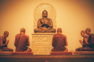 a group of buddha statues sitting on top of a table