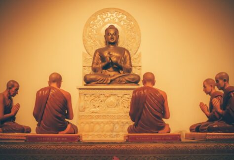 a group of buddha statues sitting on top of a table
